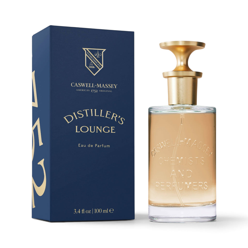 CRYOGEAR Caswell-Massey Distiller's Lounge Eau de Parfum in a glass bottle with gold cap next to a navy blue box.