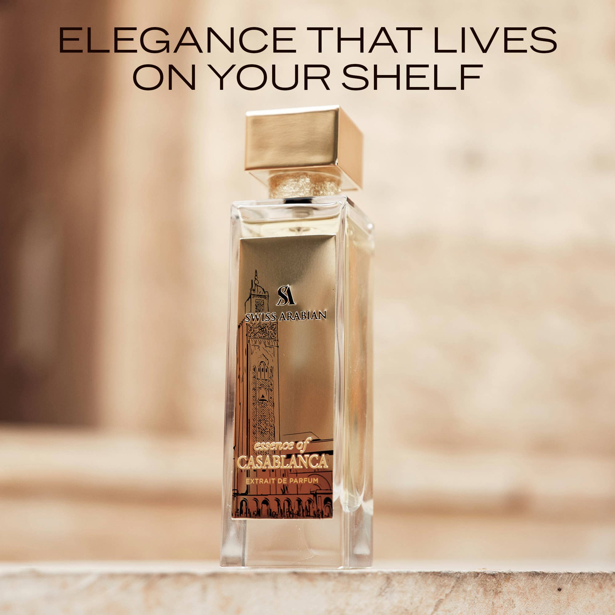 Swiss Arabian Essence of Casablanca Extrait de Parfum bottle on a stone ledge against sunlit Moroccan architecture, captioned Elegance That Lives On Your Shelf